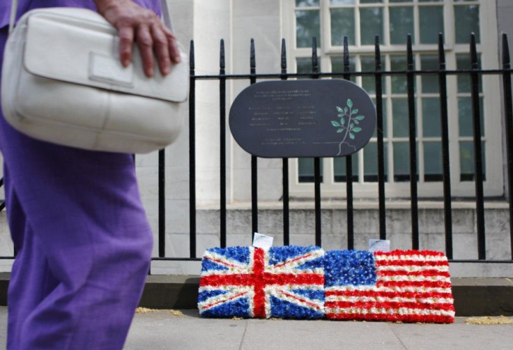 A pedestrian passes wreaths placed under a plaque commemorating the victims of the July 7 London bombing in Tavistock Square, in central London
