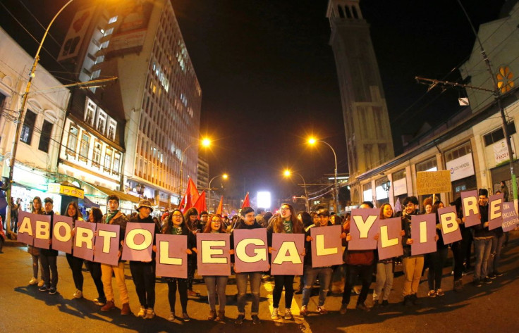 Demonstrators hold placards reading "abortion legal and free" during a march for free abortion rights and to demand an end to sexism and gender violence in the education system, in Valparaiso, Chile July 25, 2018.