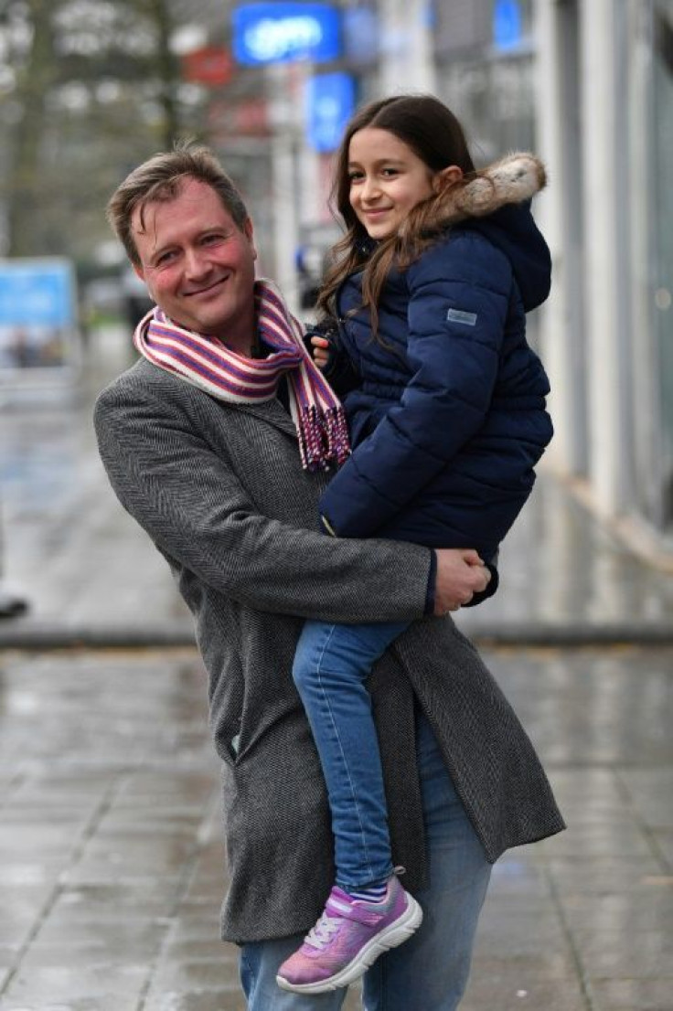 Richard Ratcliffe celebrates the release of his wife Nazanin Zaghari-Ratcliffe, a British-Iranian who had been held in Iran since 2016, as he carries their daughter Gabriella following a press briefing outside his home in London