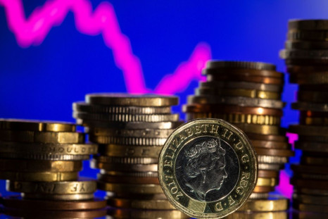 British pound coins are seen in front of displayed stock graph in this illustration taken, November 9, 2021. 