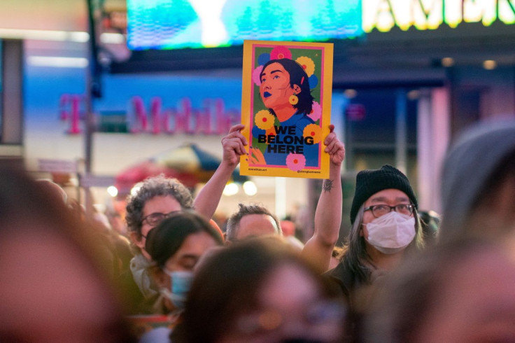 A person holds an image during a "Break The Silence - Justice for Asian Women" rally, in Times Square, in New York City, U.S. March 16, 2022.  