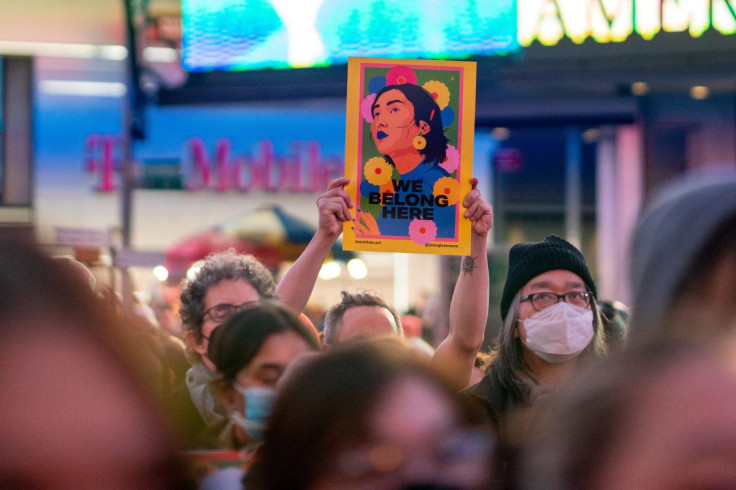 A person holds an image during a "Break The Silence - Justice for Asian Women" rally, in Times Square, in New York City, U.S. March 16, 2022.