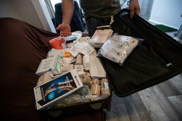 Vartan Davtian shows donated medical supplies in a suitcase he is taking with him to Europe to support the Ukrainian resistance
