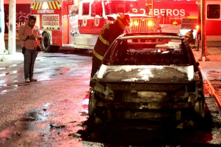 Mexican journalist Martin Patino works at the scene of a vehicle fire in the western city of Guadalajara