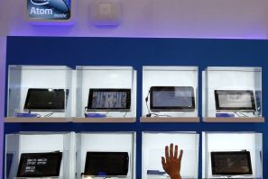 A man touches a display box at the Intel booth during the Computex 2011 computer fair