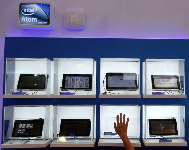 A man touches a display box at the Intel booth during the Computex 2011 computer fair