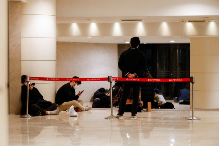 Shoppers line up outside a Chanel store in Seoul, South Korea, March 16, 2022. 