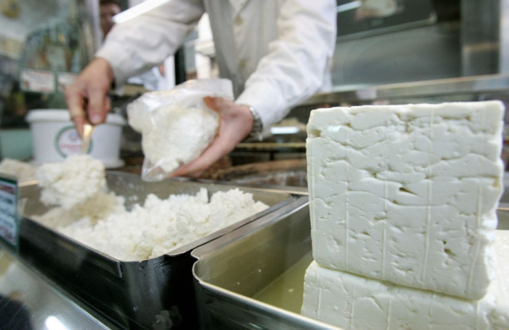 A cheesemonger puts pieces of Greece's trademark feta cheese in a bag for a customer in central Athens, November 21, 2007. 