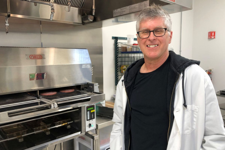 Impossible Foods Chief Executive Pat Brown poses in front of a flame broiler cooking its plant-based patties at a facility in Redwood City, California, U.S. March 26, 2019.