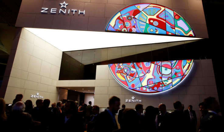 Visitors walk past the exhibition stand of Swiss watch manufacturer Zenith at the Baselworld Watch and Jewellery Show in Basel, Switzerland March 23, 2017.