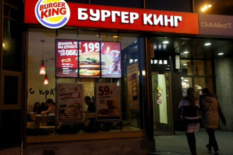 Women walk outside a Burger King restaurant in Moscow, Russia, September 15, 2015. 