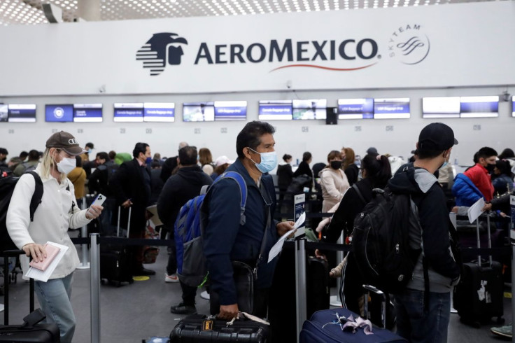 Passengers queue as they wait for flights after pilots of Grupo Aeromexico have tested positive for the coronavirus disease (COVID-19) amid the spread of the Omicron variant, at Benito Juarez International Airport in Mexico City, Mexico January 10, 2022.