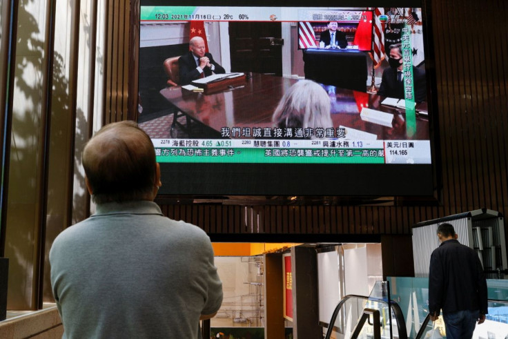 A TV screen shows news of a video meeting between U.S. President Joe Biden and Chinese President Xi Jinping, in Hong Kong, China November 16, 2021. 