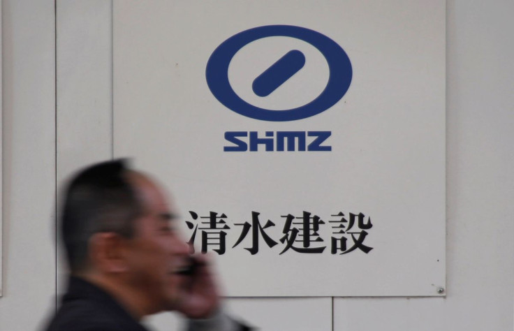 A man walks past the logo of Shimizu Corp outside a construction site in Tokyo, Japan, December 18, 2017.