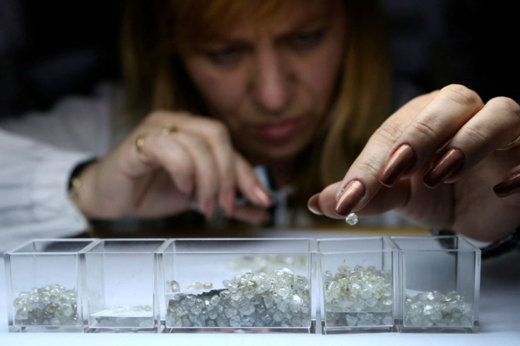 An employee sorts rough diamonds at a sorting centre, owned by Alrosa company, in Moscow, October 18, 2013. Picture taken October 18, 2013.