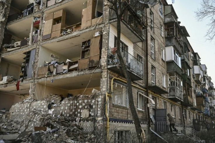 The explosion tore off the end of one block, exposing apartments with beds, chairs and shelves inside