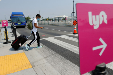 A traveler arriving at Los Angeles International Airport looks for ground transportation during a statewide day of action to demand that ride-hailing companies Uber and Lyft follow California law and grant drivers "basic employee rights'' in Los Angeles, 