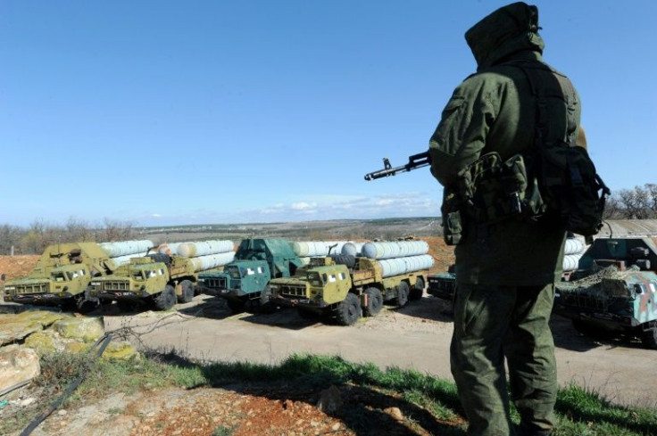 A member of the Russian armed forces guarding captured Ukrainian S300 surface-to-air missiles in Crimea in March 2014