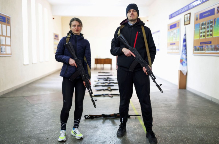 Internet marketing sales manager Maxim Yavtushenko, 32, and his girlfriend, graphic designer Olga Moroz, 26, who volunteered to join the Ukrainian Territorial Defence Forces, pose for a picture during a training session, as Russia's invasion of Ukraine co