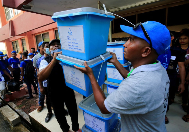 Election officers transport ballot boxes to the polling station of the East Timorese presidential election at Dili, East Timor, March 18, 2022.