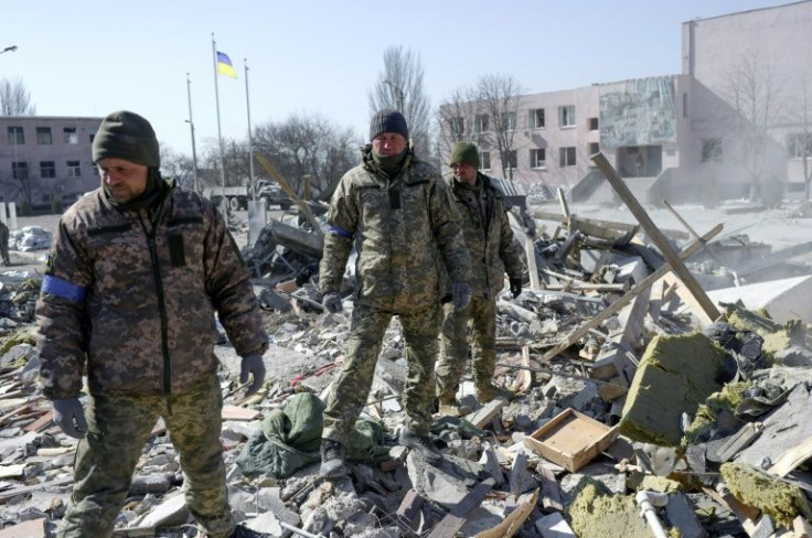 An excavator cleared the enormous heap of stones, concrete and twisted metal rods after the strike