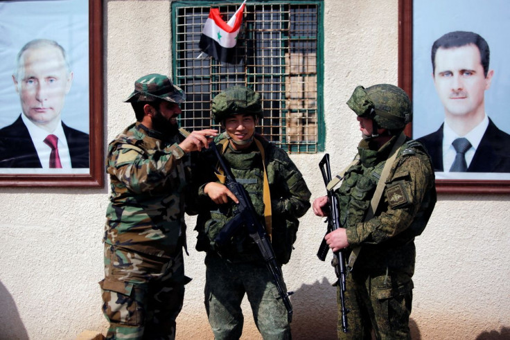 Syrian and Russian soldiers are seen at a checkpoint near Wafideen camp in Damascus, Syria March 2, 2018.