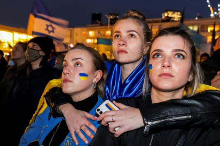 People in Tel Aviv attend the televised video address by Ukraine's president