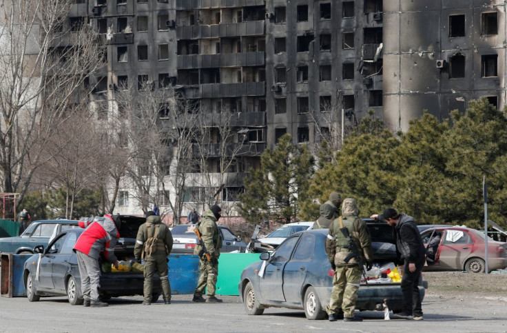 Service members of pro-Russian troops check cars during Ukraine-Russia conflict in the besieged southern port city of Mariupol, Ukraine March 20, 2022. 