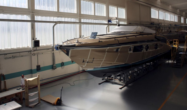 An employee works on a yacht at the Ferretti's shipyard in Sarnico, northern Italy, April 7, 2015. Picture taken on April 7, 2015.