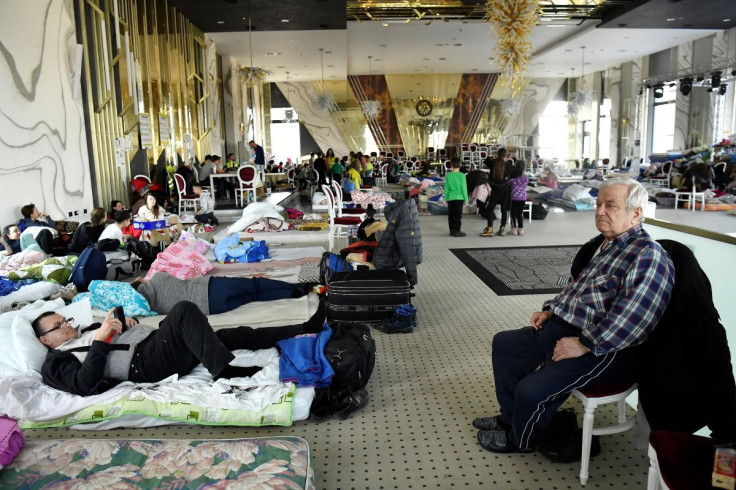 Refugees rest in a ballroom, which has been converted to a temporary shelter, at the Mandachi hotel after fleeing from Ukraine to Romania, following Russia's invasion of Ukraine, at the border crossing in Suceava, Romania, March 20, 2022. 