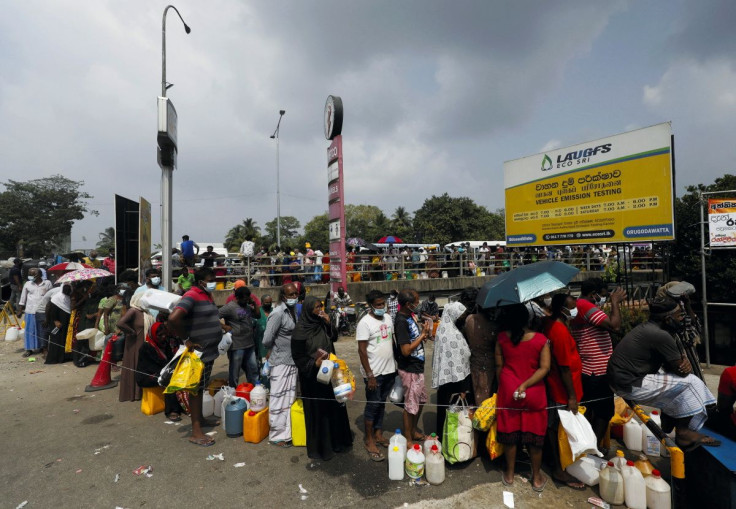 People stand in a long queue to buy kerosene oil due to shortage of domestic gas as a result of country's economic crisis, at a fuel station in Colombo, Sri Lanka March 18, 2022.