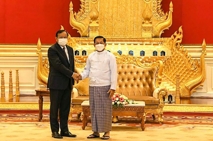 Myanmar junta chief Min Aung Hlaing (R) shakes hands with Cambodian Foreign Minister Prak Sokhonn on Monday