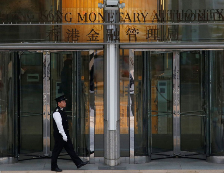 An attendant walks outside the entrance to Hong Kong Monetary Authority in Hong Kong, China November 10, 2015. 