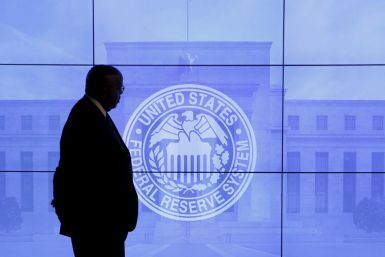 A security guard walks in front of an image of the Federal Reserve following the two-day Federal Open Market Committee (FOMC) policy meeting in Washington, March 16, 2016.  