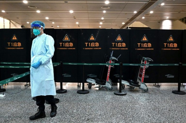 Staff in full PPE stood guard outside the waiting area in Guangzhou airport for relatives aboard the crashed jet