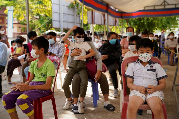Children and their parents wait to receive a vaccine against the coronavirus disease (COVID-19) at a health center as Cambodia begins to vaccinate children aged 3 to 5 years old, in Phnom Penh, Cambodia, February 23, 2022.