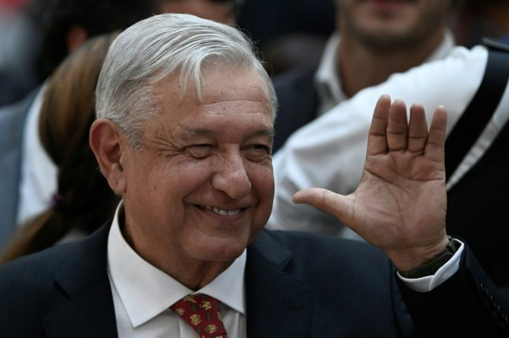 Mexican President Andres Manuel Lopez Obrador waves at the end of an inauguration ceremony for Felipe Angeles International Airport near Mexico City