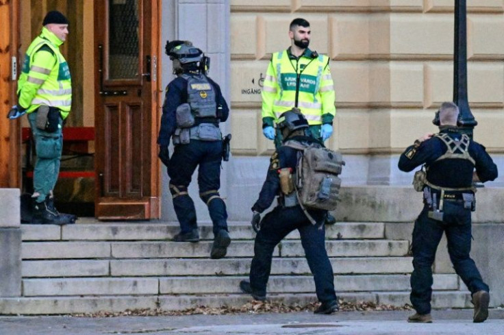 Swedish police commandos enter a building at Malmo Latinskola school in Malmo