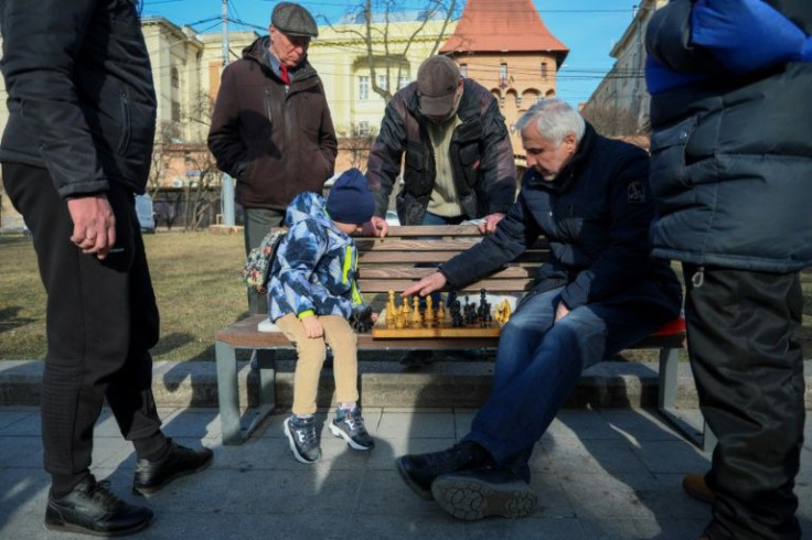 Lviv's chess fans, young and old, still gather for games on public benches along the promenade