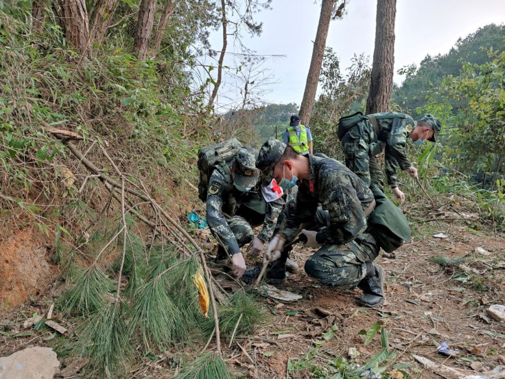 Paramilitary police officers work at the site where a China Eastern Airlines Boeing 737-800 plane flying from Kunming to Guangzhou crashed, in Wuzhou, Guangxi Zhuang Autonomous Region, China March 21, 2022. Picture taken March 21, 2022. China Daily via RE