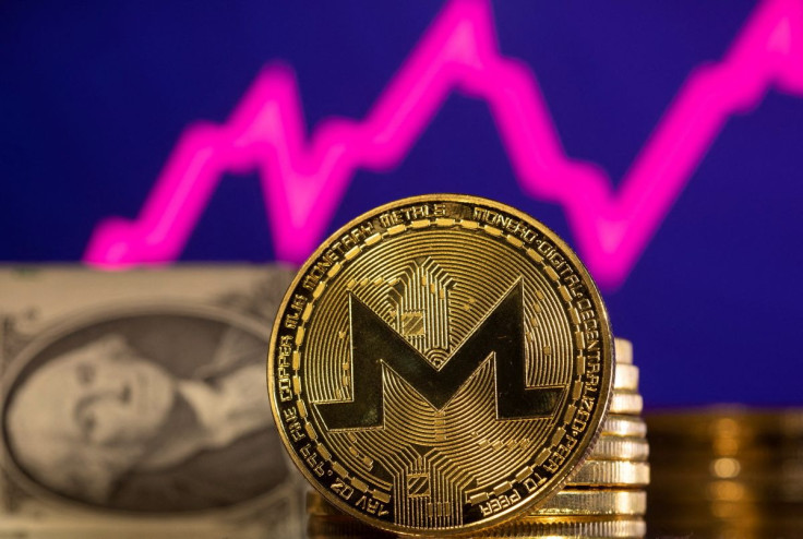 A representations of cryptocurrency  Monero is seen in front of a stock graph and U.S. dollar in this illustration taken, January 24, 2022. 
