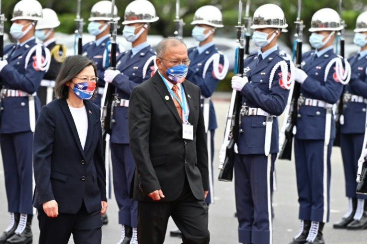 Taiwan President Tsai Ing-wen (L) and visiting Marshall Islands President David Kabua inspect honour guards during a welcome ceremony on Tuesday in Taipei