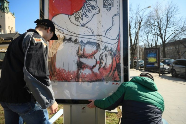 One billboard depicts Russian President Vladimir Putin's face in the dirt under a boot emblazoned with the Ukrainian trident