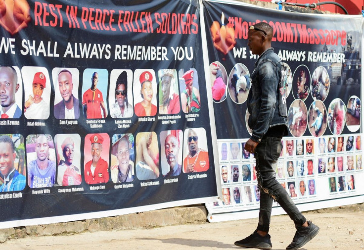 SENSITIVE MATERIAL. THIS IMAGE MAY OFFEND OR DISTURB Ronald Ssegawa, 22, a torture victim walks towards a banner of the of victims that were allegedly killed by security personnel, at the National Unity Platform offices in Kamwokya suburb of Kampala, U