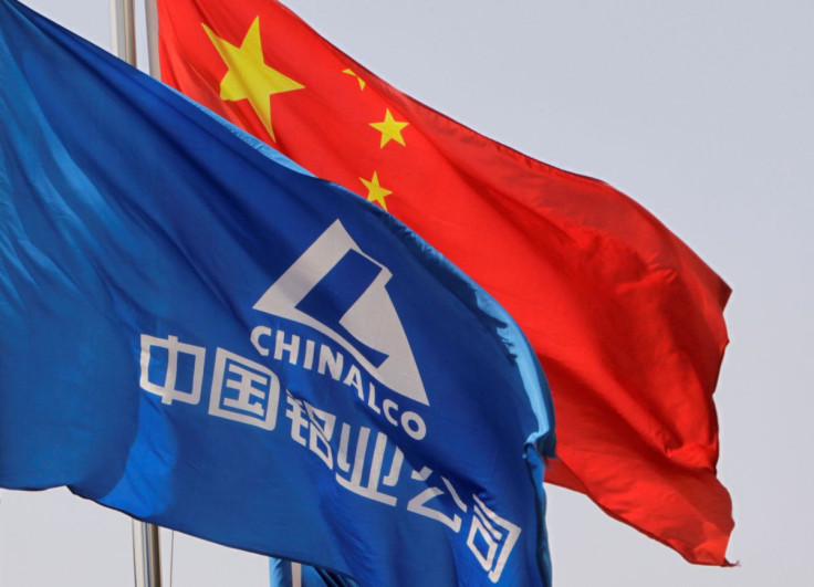 Aluminum Corp of China flag and the Chinese national flag flutter outside its headquarters in Beijing March 26, 2010.