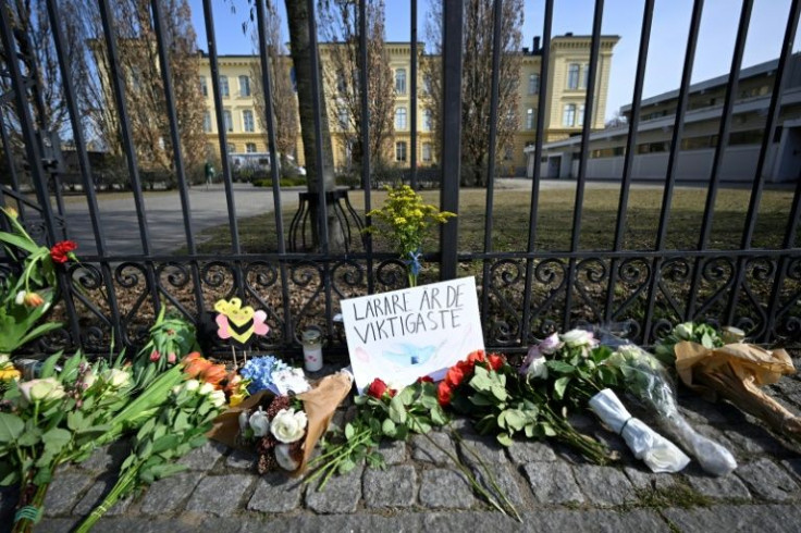 Bouquets of flowers lie outside the Malmo Latin School