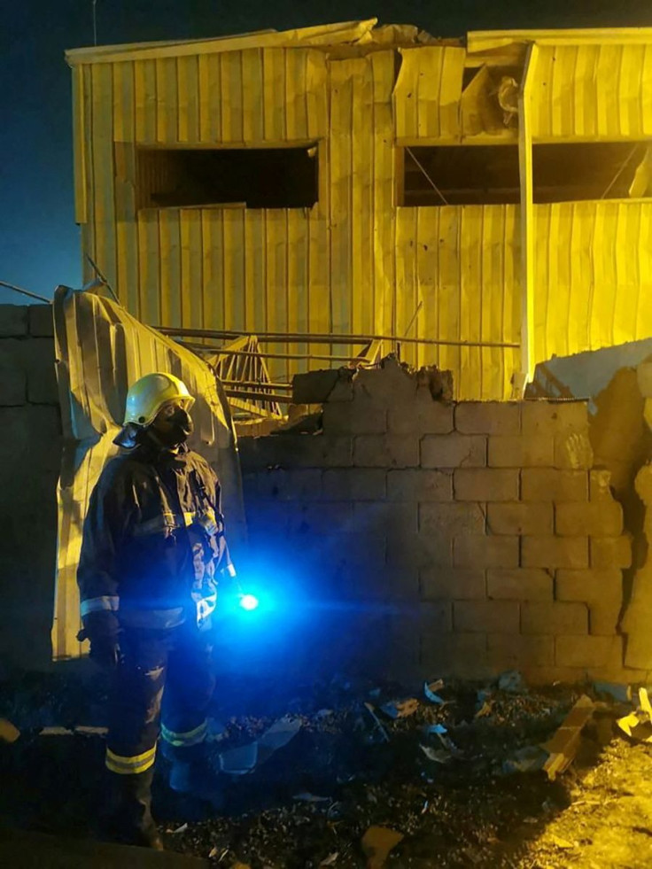 Saudi Civil Defence member is seen at the site of what Saudi-led coalition claims was a drone a attack by Yemen's Iran-aligned Houthi group, that targeted the Al-Shaqeeq desalination plant and the Aramco facility, in Jizan, Saudi Arabia, March 20, 2022. S