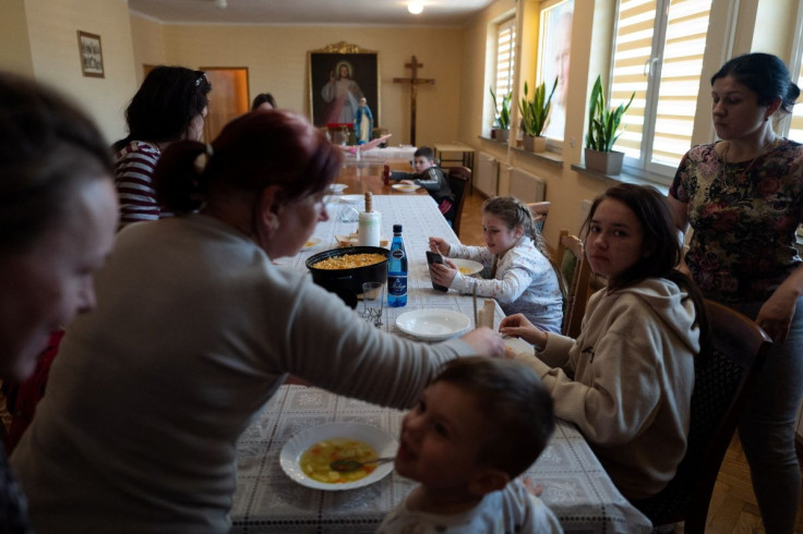 Ukrainian refugees who fled Russia's invasion of Ukraine eat at a living room at a clergy house in Lubaczow, Poland March 21, 2022. Polish Catholic priest Roman Karpowicz hosts women with children from Ukraine who fled the invasion at the clergy house.