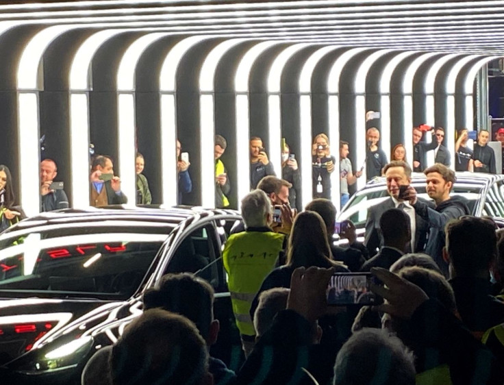 People take pictures of Elon Musk during a delivery ceremony inside the new Tesla Gigafactory for electric cars in Gruenheide, Germany, March 22, 2022. 