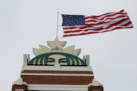 A flag flies above the company's headquarters as Starbucks Corp opens the first upscale Starbucks Reserve store at the Starbucks headquarters in Seattle, Washington, U.S., February 27, 2018.  
